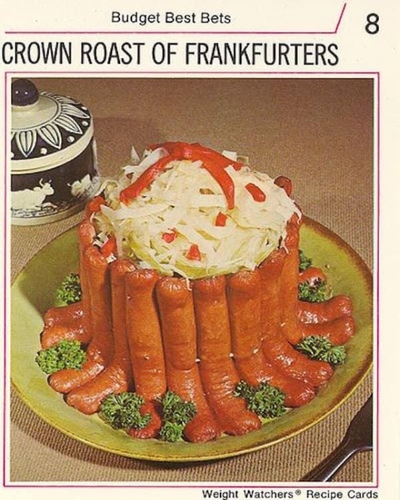 Text: Budget Best Bets - A Crown of Roast Frankfurters - Weight Watchers recipe cards. The image shows halved hot dogs in a ring create a bowl for sauerkraut.